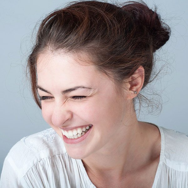 Young woman smiling after her tooth extraction